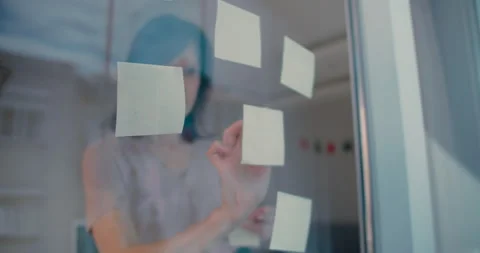 Woman using sticky notes brainstorming ideas problem solving Stock Footage 238860310