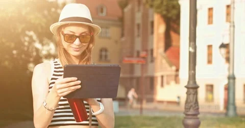 Woman using tablet and drinking coffee in the sunny European city. Slow Motion. 스톡 동영상 53716878