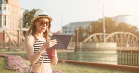 Woman using tablet and drinking coffee in the sunny European city. Slow Motion. Stock Footage 53721719