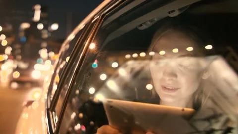 Woman Using a Tablet and Looking Through the Window Stock Footage 84771787