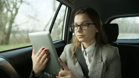 Woman Using a Tablet and Looking Through the Window Stock Footage 84941846