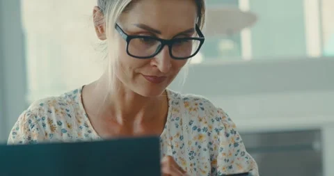 Woman Using Tablet and Smartphone in Modern Kitchen Stock Footage 323583045