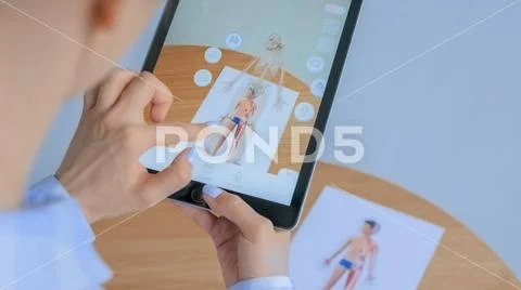 Photograph: Woman using tablet with augmented reality app: 3d model of ...