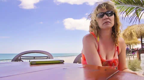 Woman using tablet at beach Stock Footage 23233696