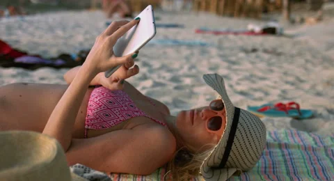 Woman Using a Tablet at the Beach Stock Footage 61157889
