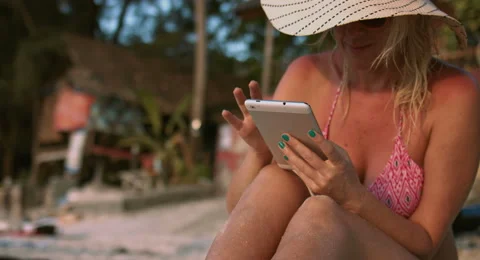 Woman Using a Tablet at the Beach Stock Footage 61158019