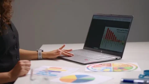 Woman using tablet beside laptop while analyzing business charts and digital Vídeo Stock 342477182