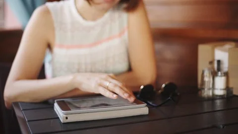 Woman using tablet in cafe Stock Footage 77560162