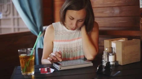 Woman using tablet in cafe Video stock 77560275
