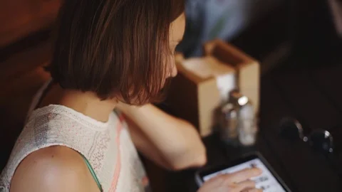 Woman using tablet in cafe Video stock 77560544
