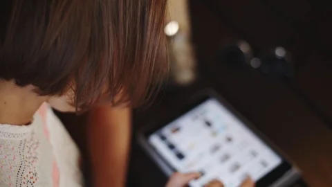Woman using tablet in cafe Stock Footage 77560897