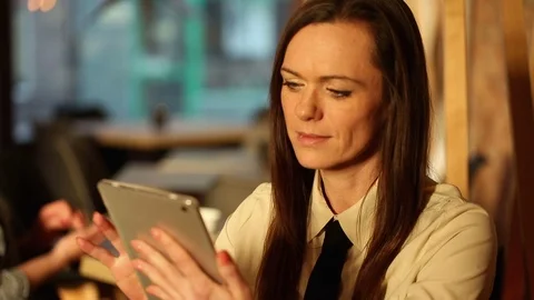 Woman using tablet computer in cafe Stock Footage 72319803