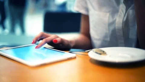 Woman using tablet computer in cafe Stock Footage 77951149