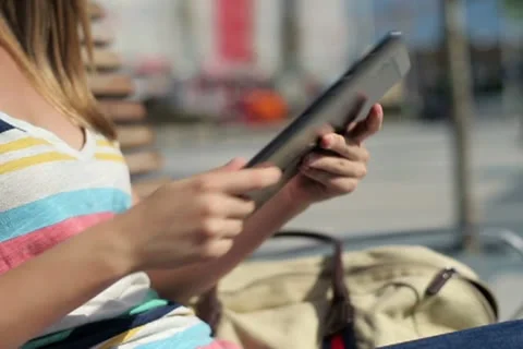 Woman using tablet computer in the city, steadicam shot NTSC Stock Footage 12133570