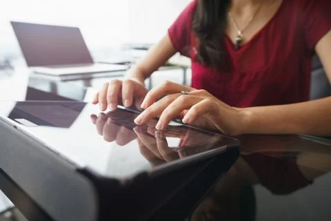 Woman using tablet computer for daily work in office Stock Photos