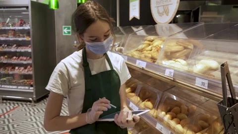 Woman Using Tablet Computer In Grocery Store Stock Footage 169750053