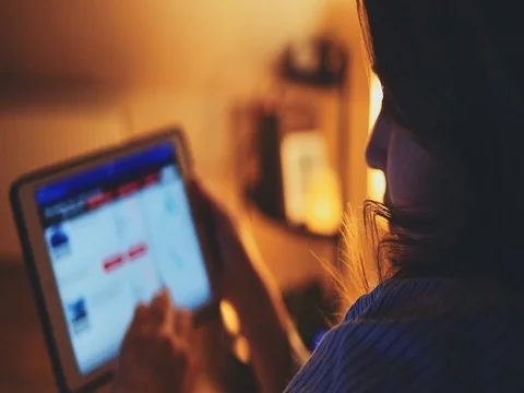 Woman using Tablet Computer at night at home. SLOW MOTION 4K DCi. Stock Footage 75669852