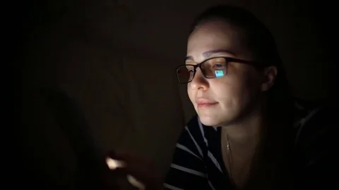 Woman using Tablet Computer at night.. Young millennial consumer shopping online Stock Footage 84701839