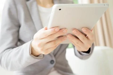 Woman using a tablet computer. Stock Photos