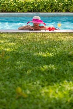 Woman using tablet computer in pool Stock Photos