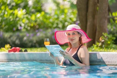 Woman using tablet computer in pool Stock Photos