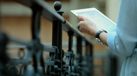 Woman using a tablet computer with a touch screen writes a message to a friend. Stock Footage 68905714