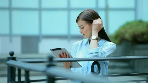 Woman using a tablet computer with a touch screen writes a message to a friend. Stock Footage 68905730