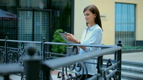 Woman using a tablet computer with a touch screen writes a message to a friend. Stock Footage 68905759