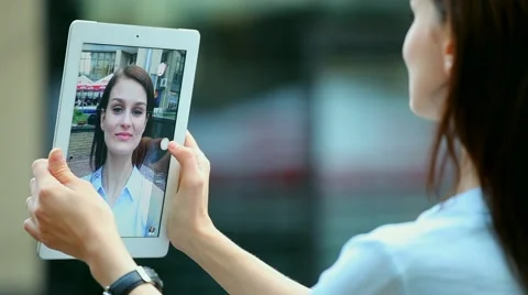 Woman using a tablet computer with a touch screen writes a message to a friend. Stock Footage 68905761