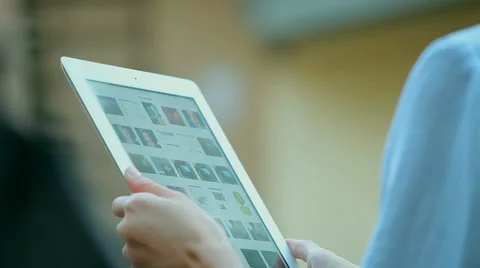 Woman using a tablet computer with a touch screen writes a message to a friend. Stock Footage 68905792