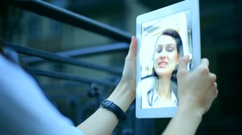 Woman using a tablet computer with a touch screen writes a message to a friend. Stock Footage 68905916
