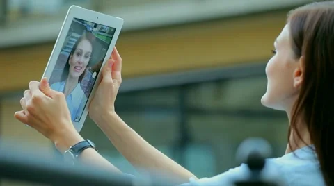 Woman using a tablet computer with a touch screen writes a message to a friend. Stock Footage 68906385