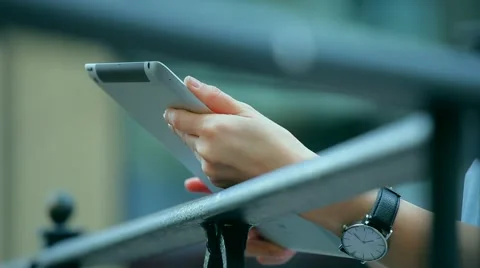 Woman using a tablet computer with a touch screen writes a message to a friend. Stock Footage 68906503