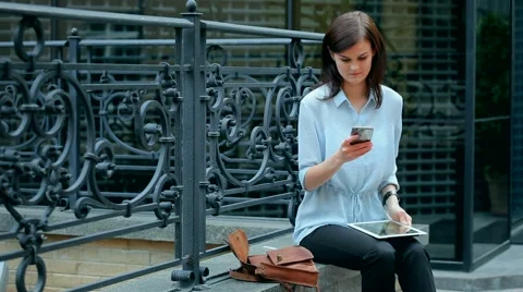 Woman using a tablet computer with a touch screen writes a message to a friend. Stock Footage 68906780