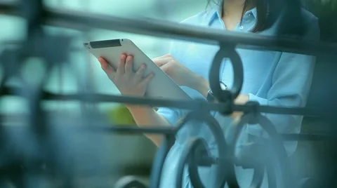 Woman using a tablet computer with a touch screen writes a message to a friend. Stock Footage 68906899