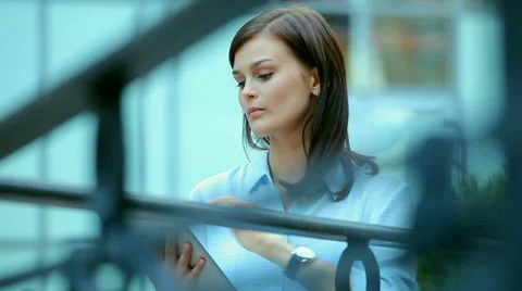 Woman using a tablet computer with a touch screen writes a message to a friend. Stock Footage 68907138