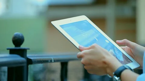 Woman using a tablet computer with a touch screen writes a message to a friend. Stock Footage 68907194