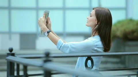 Woman using a tablet computer with a touch screen writes a message to a friend. Stock Footage 68907241