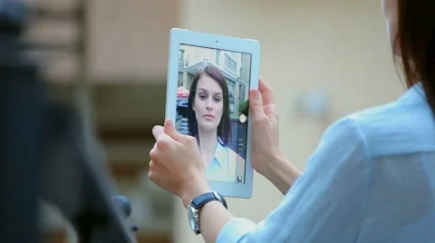 Woman using a tablet computer with a touch screen writes a message to a friend. Stock Footage 68907354