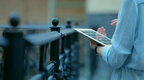 Woman using a tablet computer with a touch screen writes a message to a friend. Stock Footage 68907368