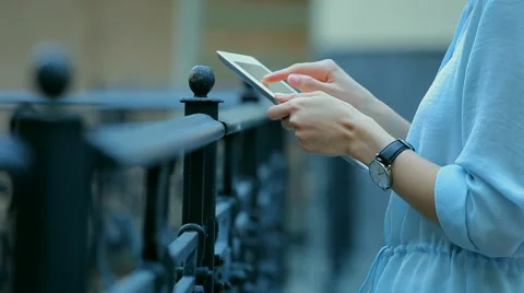 Woman using a tablet computer with a touch screen writes a message to a friend. Stock Footage 68907444