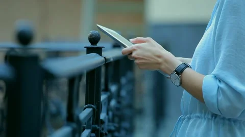 Woman using a tablet computer with a touch screen writes a message to a friend. Stock Footage 68907526