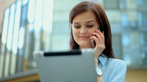 Woman using a tablet computer with a touch screen writes a message to a friend. Stock Footage 68907802