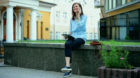 Woman using a tablet computer with a touch screen writes a message to a friend. Stock Footage 68908138