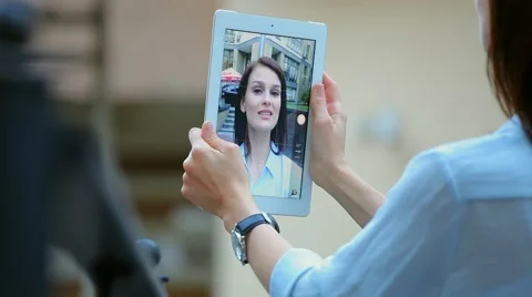 Woman using a tablet computer with a touch screen writes a message to a friend. Stock Footage 68908360