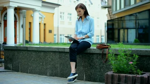 Woman using a tablet computer with a touch screen writes a message to a friend. Stock Footage 68908390