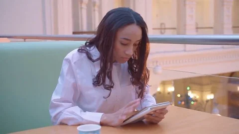 Woman using tablet computer touchscreen in cafe Video stock 69079291