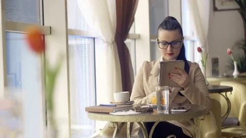 Woman using tablet computer touchscreen in cafe 1920x1080 스톡 동영상 73417300