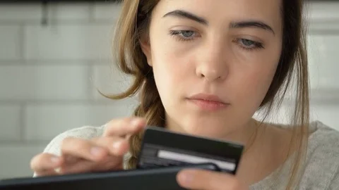Woman using tablet computer touchscreen in cafe drinking coffee. Girl doing Stock Footage 73811512