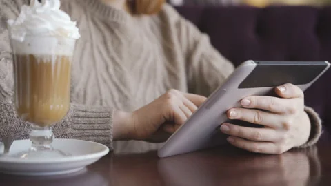 Woman using tablet computer touchscreen in cafe Stock Footage 98132035